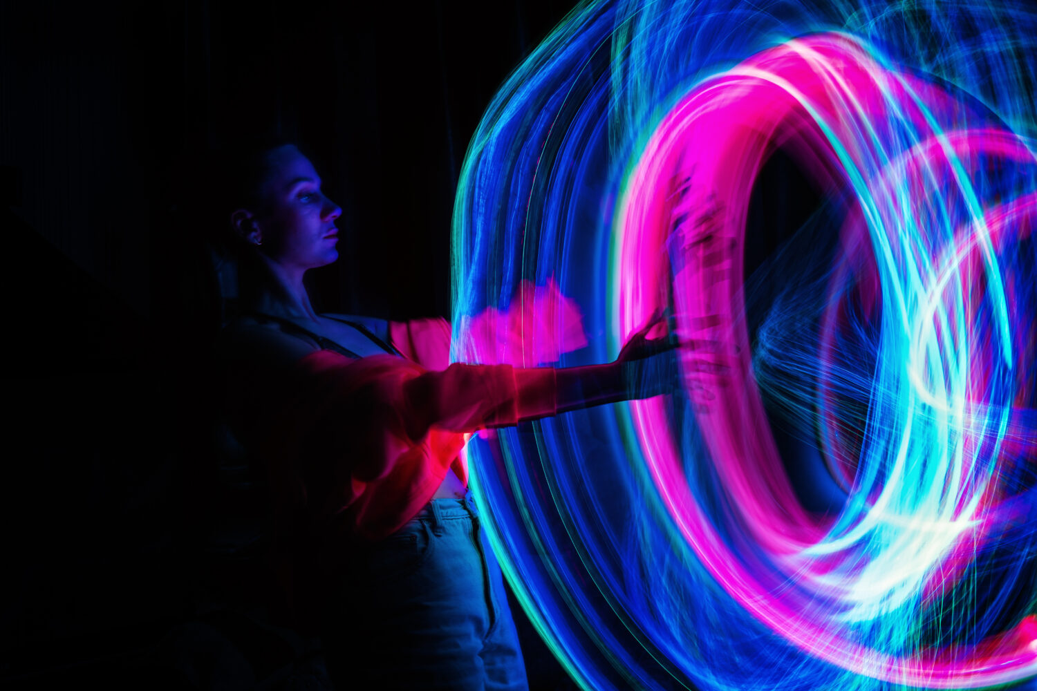 Digital avatar of a woman in a virtual reality setting with neon blur lines